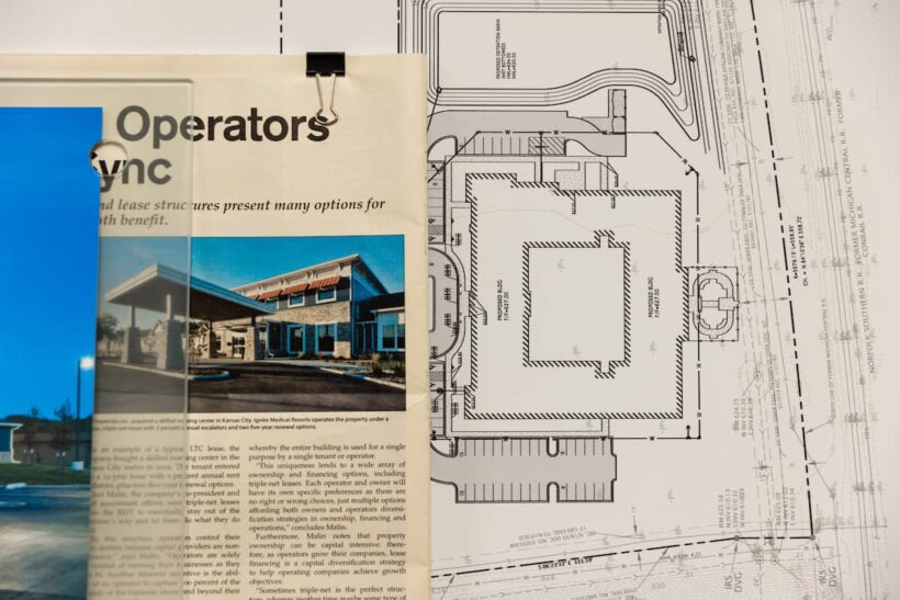 Newspaper clippings and blue prints