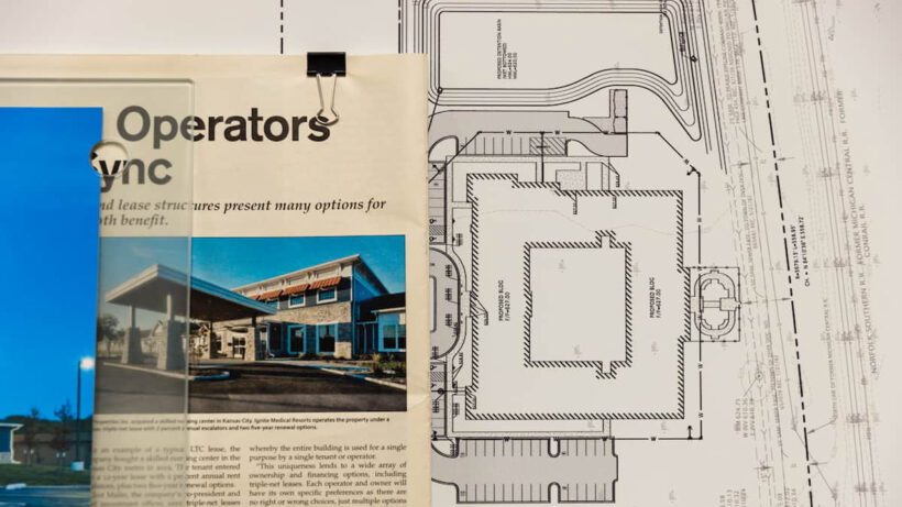 Newspaper clippings and blue prints